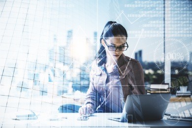 attractive young woman working on project at abstract workplace with city view and laptop. lifestyle and job concept. double exposure 