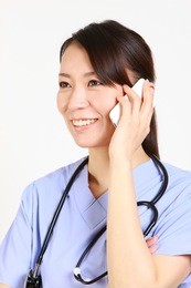 young japanese female doctor talks with a smart phone