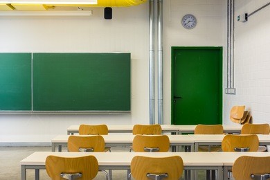 empty wooden chairs at tables depth of field lecture hall nobody green chalkboard university education college higher