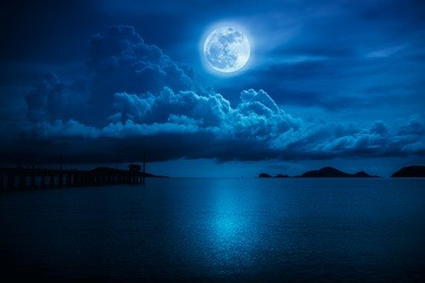beautiful landscape view of the sea. colorful blue sky with clouds and bright full moon on seascape to night. serenity nature background, outdoor at nighttime. the moon taken with my own camera.