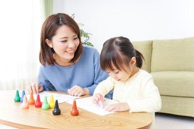 a parent and child painting a picture