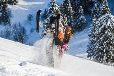 rider on the snowmobile in the mountains ski resort in sakhalin island russia.
