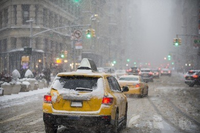 a winter snowstorm brings traffic and pedestrians to a slow crawl on fifth avenue. 