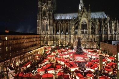 the famous german cologne cathedral christmas market with illumination, christmas tree and cathedral in the background.