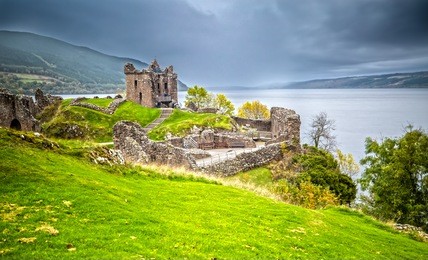 urquhart castle with dark cloud sky