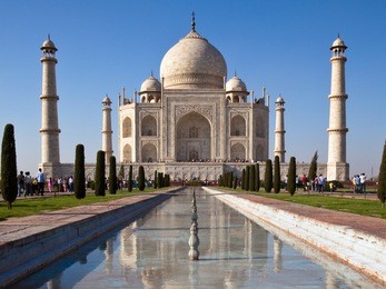 classic view of taj mahal with reflections in a pond in agra, india.