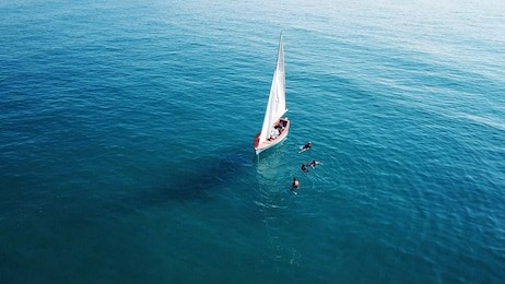 aerial view of sailboat - sailing school - people in the water