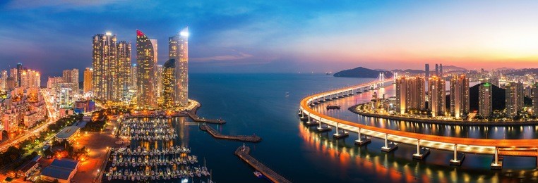 sunset in busan city with building, bridge and harbor, korea, asia