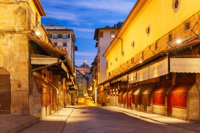 view across the famous bridge ponte vecchio at night in florence, tuscany, italy