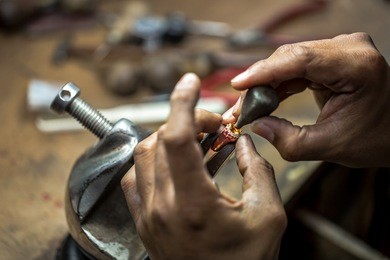 thai jeweler, handles the jewelry and precious stones in the workshop, the process of jewelry making ,close-up