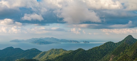 panoramic view of blue sky, sea and mountain seen from cable car viewpoint, langkawi, malaysia. picturesque landscape with tropical forest, beaches, small islands in waters of strait of malacca