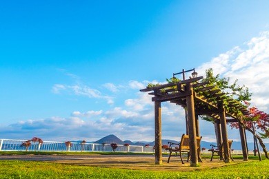 sitting bench near toya lake. lake toya in toyako town, hokkaido, japan.  lake toya in beautiful morning with clear blue sky and mountain background. 