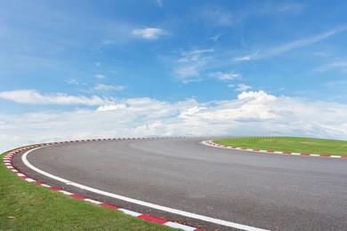 asphalt road with green grass ,blue sky background