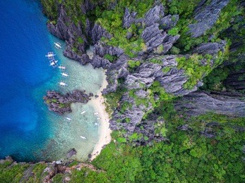 el nido, palawan, philippines, aerial view of boats moored at secret lagoon beach.