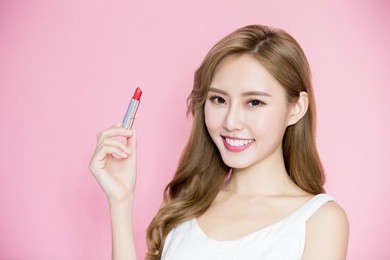 beauty skincare woman take lipstick on the pink background