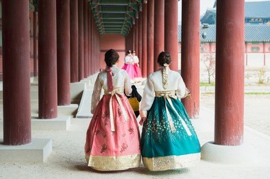 asian korean girls dressed hanbok in traditional dress walking in gyeongbokgung palace at seoul, south korea
