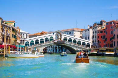 venice grand canal with gondolas and rialto bridge, italy in summer bright day