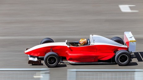motion blur, race car racing on speed track, car race on the international race track crossing finish line.
