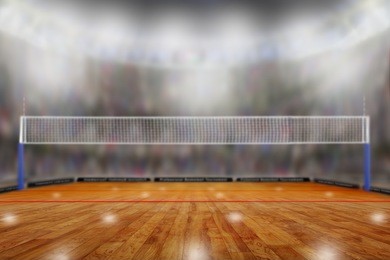 low angle view of volleyball arena with sports fans in the stands and copy space. focus on foreground with deliberate shallow depth of field on background.