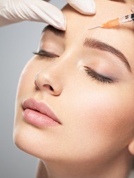 woman getting cosmetic injection of botox near eyes, closup. woman in beauty salon. plastic surgery clinic.