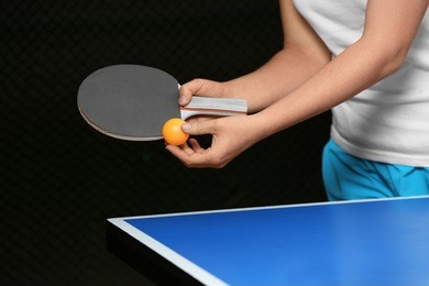 woman playing table tennis indoors