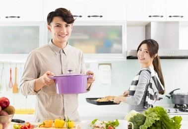 young asian couple cooking in kitchen