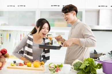 happy young couple cooking in the kitchen