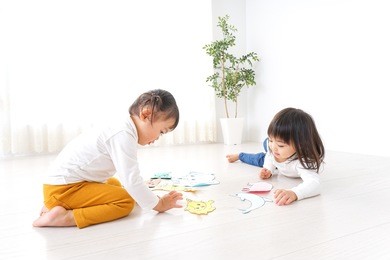 two children playing in room