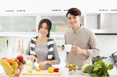 happy young couple cooking in the kitchen