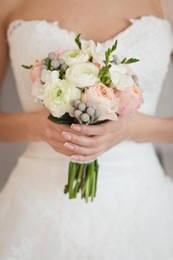 bride's bouquet in her hands. beautiful wedding bouquet in hands of a bride. selective focus. young bride holding the wedding bouquet, with pink and white flowers, close-up