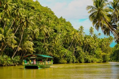 davao's famous river, loboc river and a boat that caters tourists with a lunch buffet.