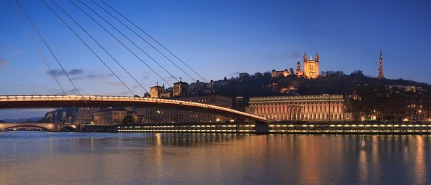 panorama of footbridge passerelle palais du justice over the saone river in lyon during twilight.