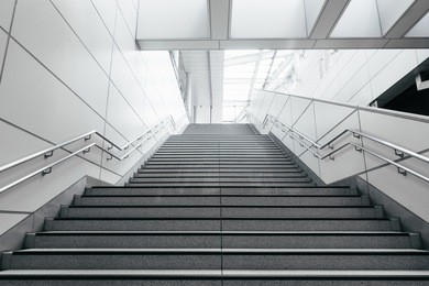 stairs from underground upward in modern city space.