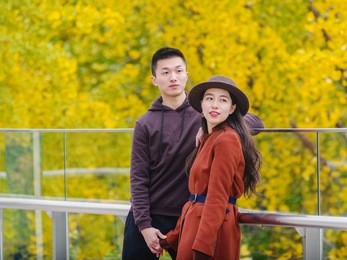 chinese young man and woman holding hands and standing together with emotional expression, lover concept.
