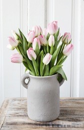 bouquet of pink tulips in grey ceramic vase.