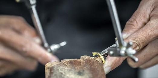 thai jeweler, handles the jewelry and precious stones in the workshop, the process of jewelry making ,close-up