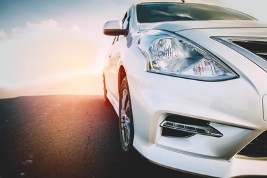 car traveling in nature on an asphalt road - front view