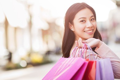 a shot of an asian woman shopping outdoor