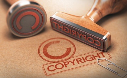 3d illustration of two rubber stamps with copyright word and symbol over kraft paper background, concept of copyrighted material