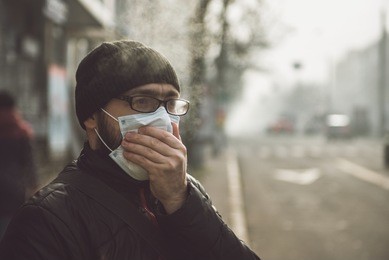 a man wearing a mask on the street. protection against virus and grip