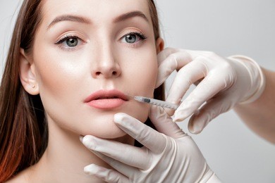 portrait of beautiful woman getting injection on lips. beauty injections and cosmetology