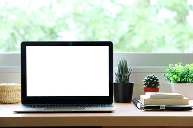 blank screen laptop on the desk at
home office