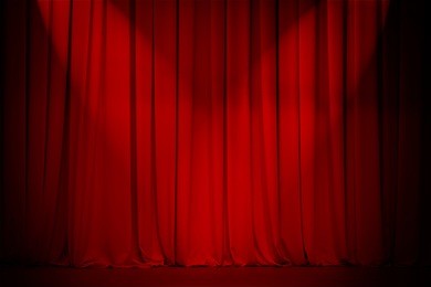 theater stage red curtain with two spotlights cross