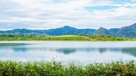 mountain range and lake at singha park chiang rai, thailand.
