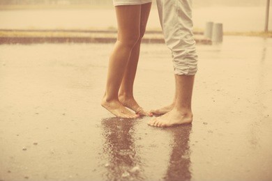 loving couple in the rain barefoot. a man and a woman in love.