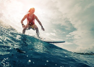 young surfer rides the ocean wave. extreme sport and action concept
