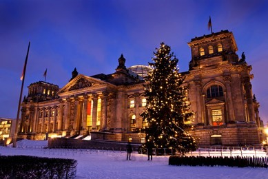reichsatg building in winter with christmas tree and snow in berlin