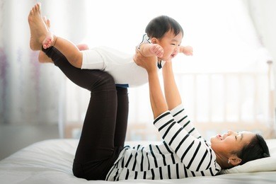 asian mother play with her baby on the bed,  mother, kid, home, baby and family concept