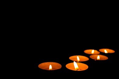 round candles on a black background