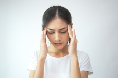 woman touching her head with hands. young asian woman feel headache. isolated on white background.